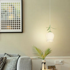 A flower pendant light hanging in a living room setting, with a grey sofa and a piece of abstract art on the wall.
