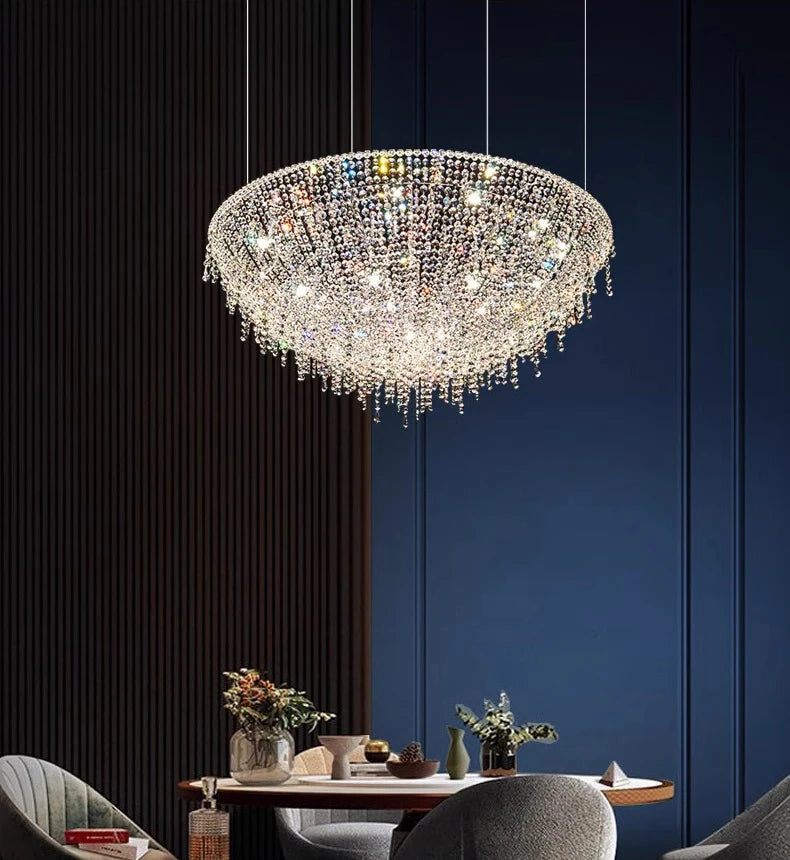 Crystal chandelier hanging above a dining table with a dark blue wall background