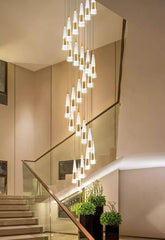 Modern staircase with a decorative light fixture in a well-lit interior setting.
