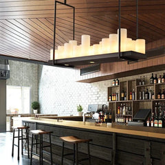 Modern bar interior with wooden ceiling, stools, and shelves with bottles.
