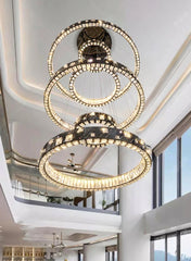 Luxurious chandelier hanging from a ceiling in a modern interior setting.