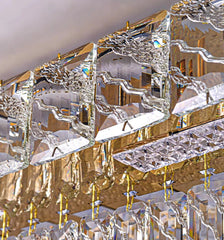 Close-up of a crystal chandelier with gold accents