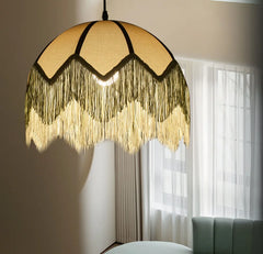 Close-up of a fringed pendant light shade with intricate weaving and tassels.