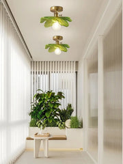 Modern interior design with green ceiling lights and plants.