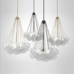 Modern chandelier with white glass balls and metal baskets on a light gray background