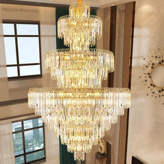 Luxurious chandelier in a room with large windows and decorative wall art.
