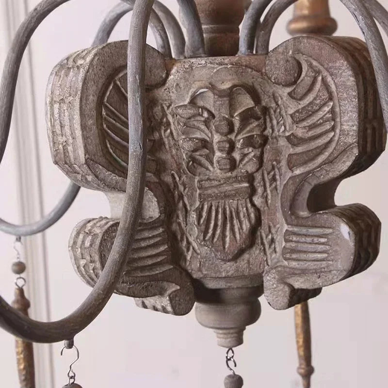 Decorative metal chandelier with intricate design on a neutral background