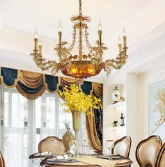 Luxurious dining room with a grand chandelier, ornate chairs, and decorative elements.