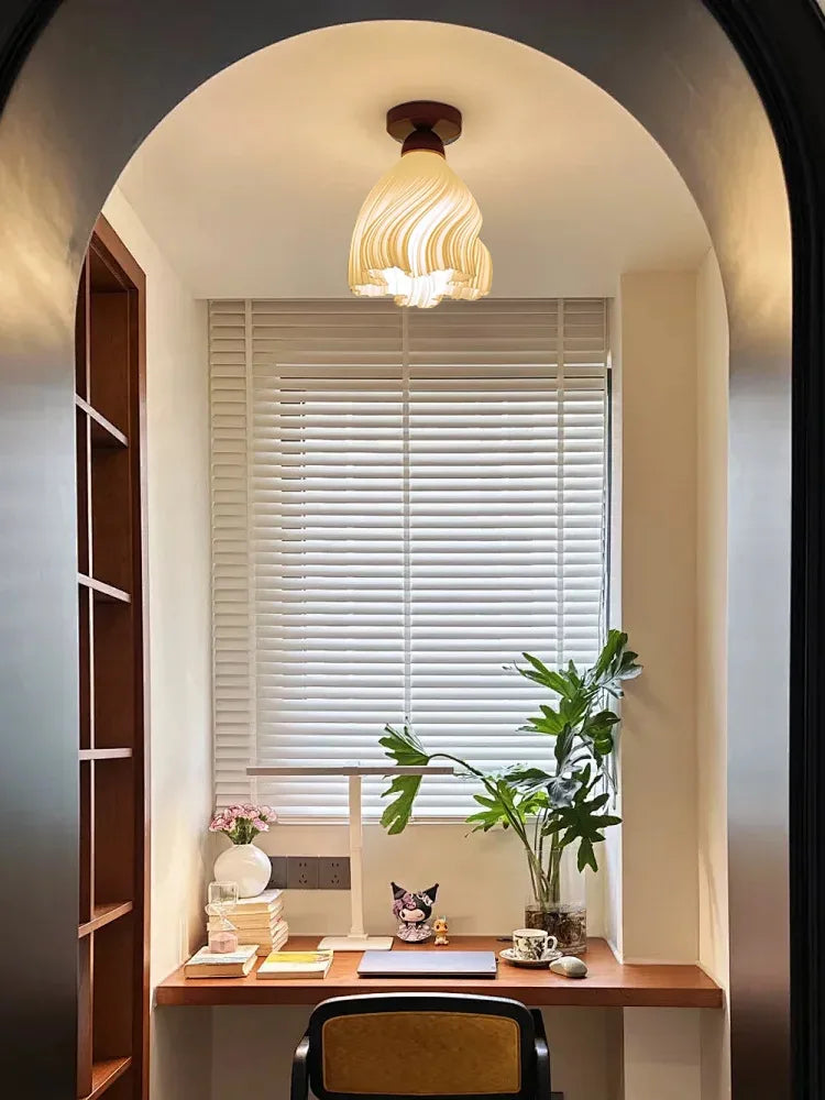 Small home office with a desk, chair, and decor elements.