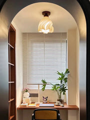 Small home office with a desk, chair, and decor elements.