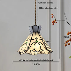 Pendant light with stained glass shade and measurements on a gray background
