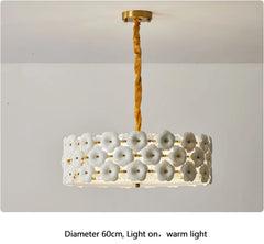 Decorative ceiling light fixture with floral design on a plain background