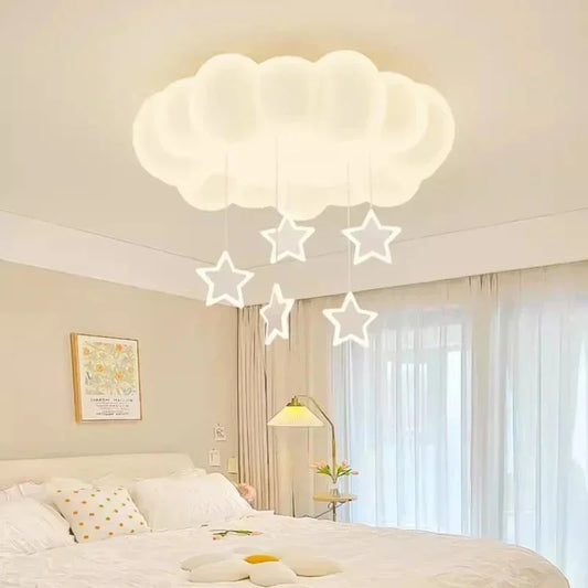 White cloud-shaped ceiling light with white stars hanging down, installed in a bedroom.