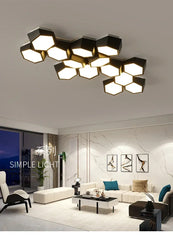 Modern ceiling light fixture in a living room setting with marble walls and a white sofa.
