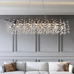 Luxurious chandelier hanging above a sofa in a modern living room.