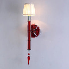 Decorative wall sconce with red and clear glass design on a white background
