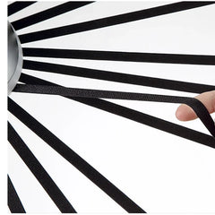 Black and white striped object with a hand holding one end