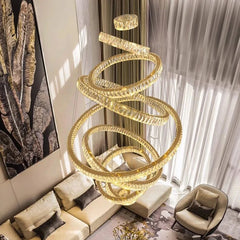 Gold spiral chandelier in a living room setting with a couch and chair.