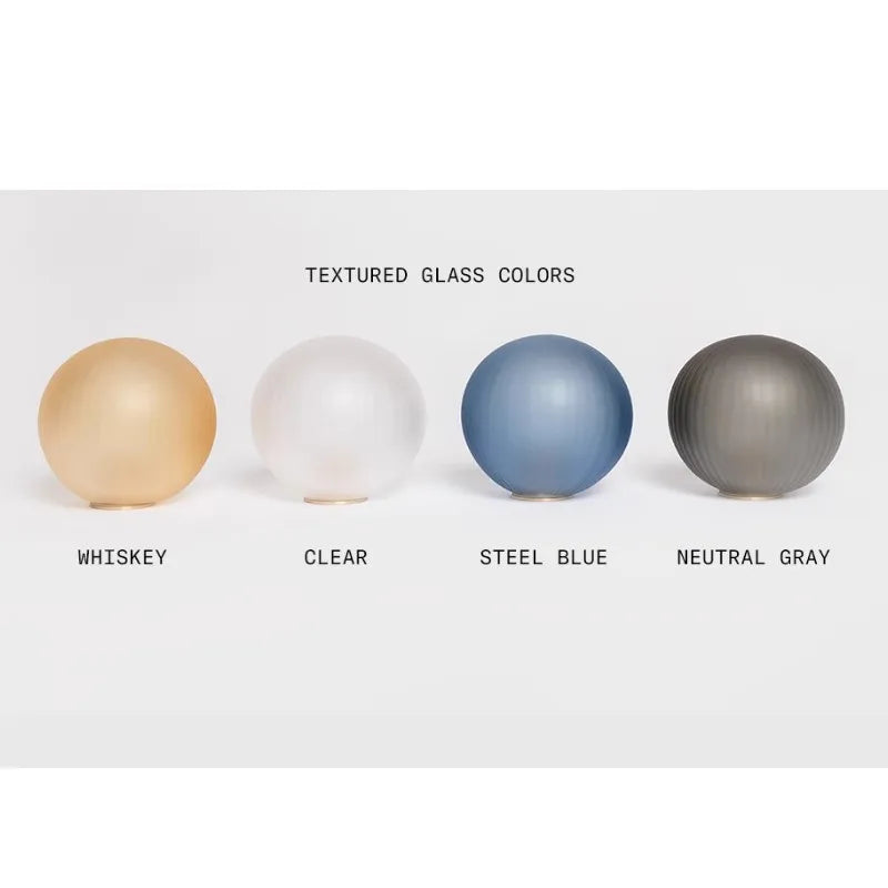 Four textured glass spheres in different colors on a white background