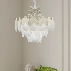 Close-up of the white glass leaf tiered chandelier with intricate details