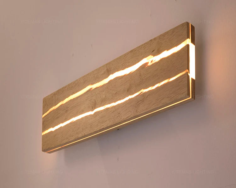 Modern wall light fixture with wooden finish and embedded lights on a neutral background