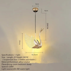 Gold swan-shaped pendant light with dimensions on a gray background