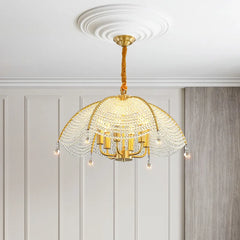 An upward angled view of a gold fan-shaped crystal chandelier suspended from a decorative ceiling medallion, highlighting its intricate design.