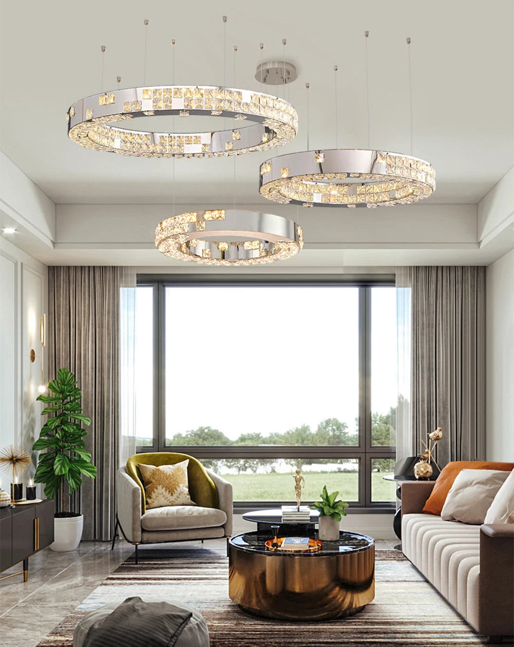 Modern living room with three circular chandeliers, a sofa, and a coffee table.