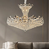 Polished chrome tiered chandelier with cascading crystal and floral accents, illuminated in a living room setting.