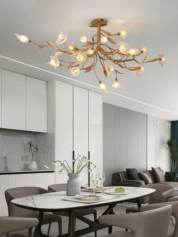 Modern chandelier hanging above a dining table in a stylish room.