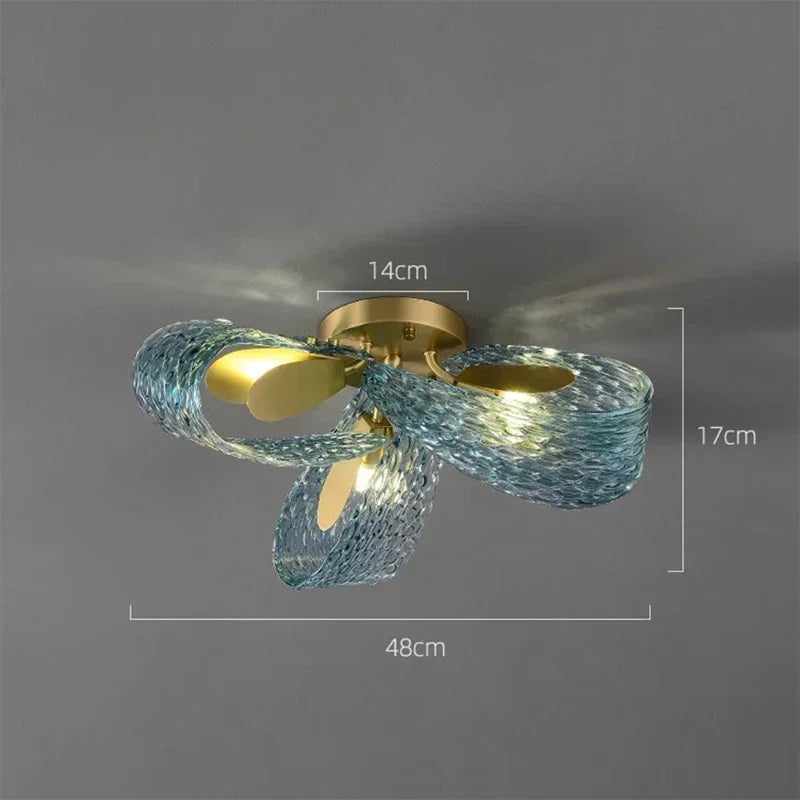 Ceiling light fixture with blue glass shades and gold metal components, shown against a dark background with measurements indicated.