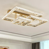 Gold geometric flush mount ceiling light with multiple rectangular frames adorned with clear crystals, viewed from below against a white ceiling.