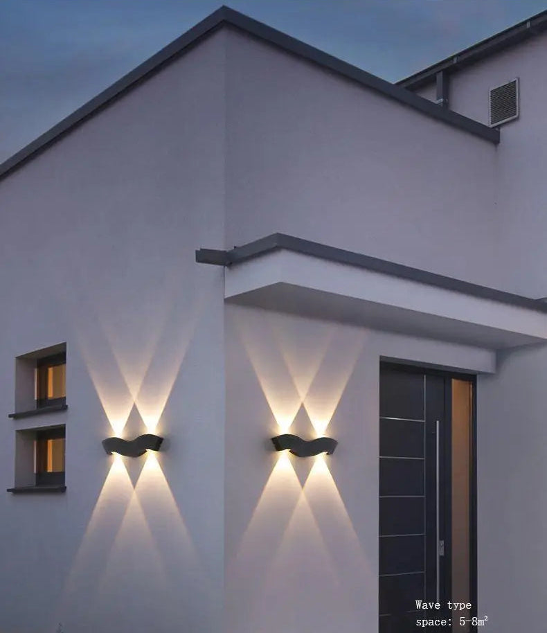Modern house exterior with wall-mounted lights at dusk