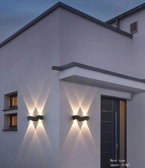 Modern house exterior with wall-mounted lights at dusk
