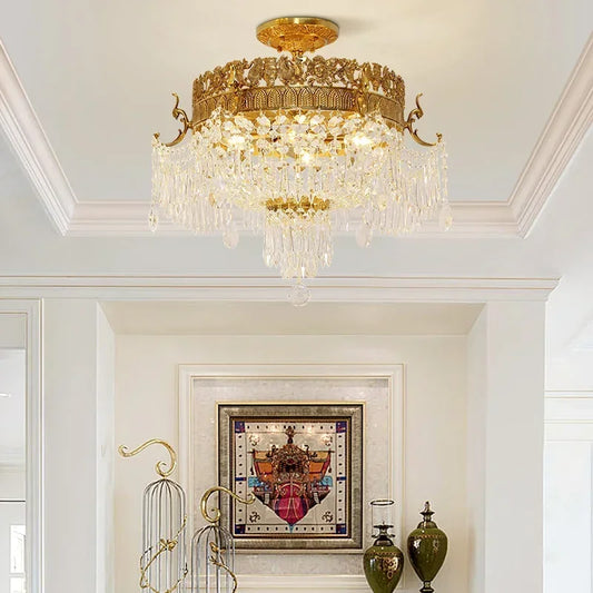 Gold semi-flush ceiling light with cascading crystal droplets and ornate gold trim mounted on a white ceiling.