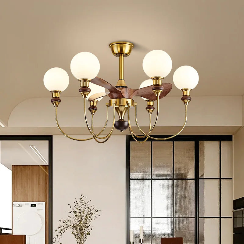 Modern chandelier with gold finish and white glass bulbs in a room setting.