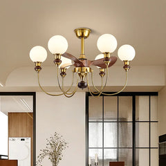 Modern chandelier with gold finish and white glass bulbs in a room setting.