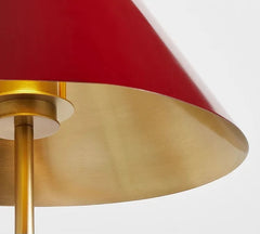 Close-up of a red lampshade with gold base on a white background