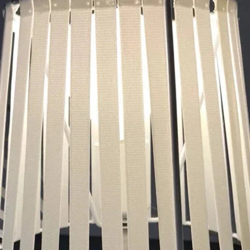 Close-up of a white vertical blind with a blurred background