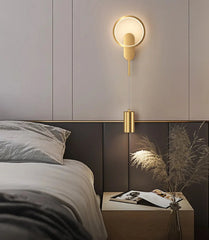 Modern bedroom with a wall-mounted lamp and a nightstand.