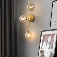 Modern Gold Brass Sconce with Three Frosted Globe Shades