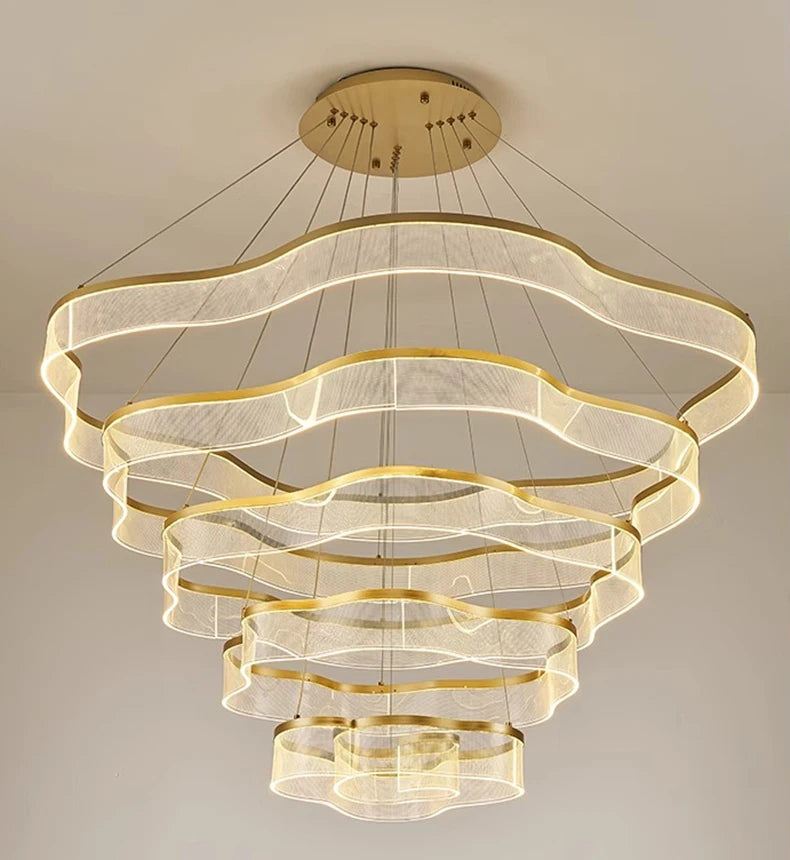 Modern chandelier with gold accents on a neutral background