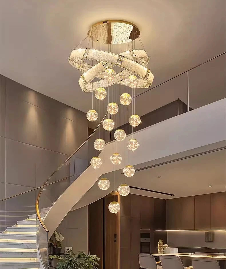 Modern chandelier hanging above a staircase in a stylish interior setting.