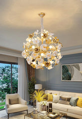 Gold floral chandelier with ceramic petals hanging in a living room