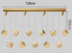 Gold pendant light fixture with crystal-like shades, shown with dimensions on a gray background.