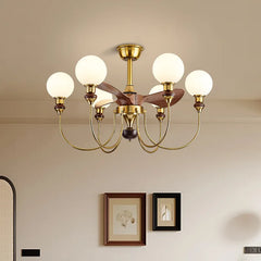 Gold chandelier with white lights in a room with framed pictures on the wall.