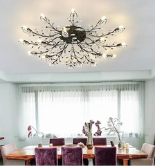 Modern ceiling light fixture in a dining room with a table and chairs.
