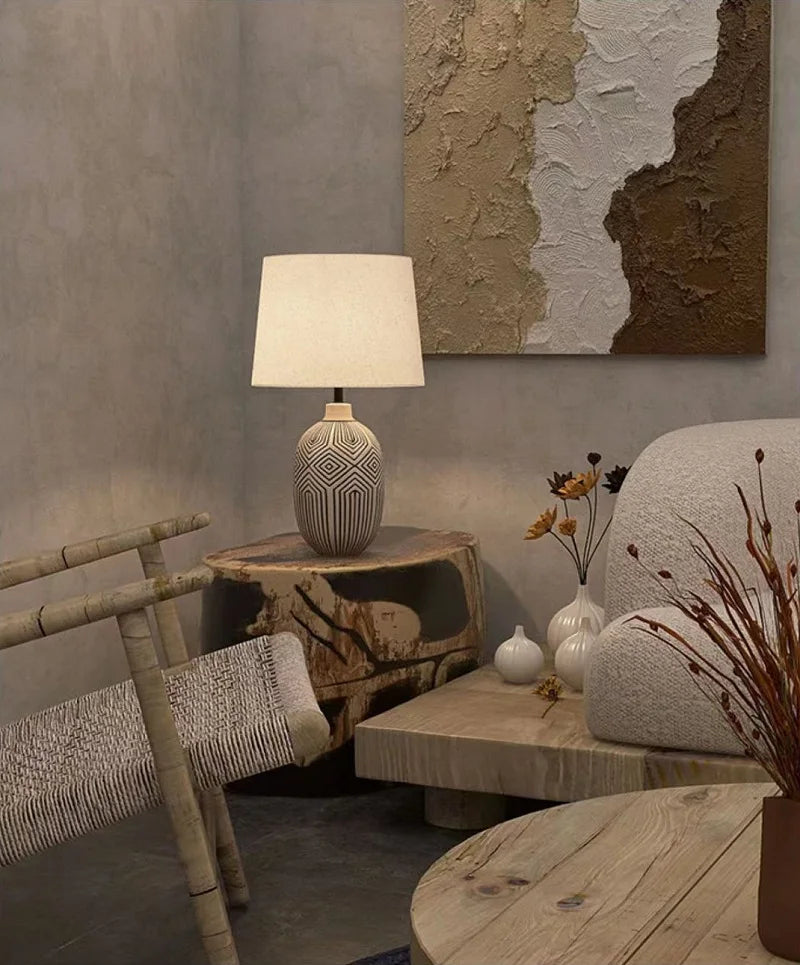 Living room with textured wall, lamp, and decorative elements