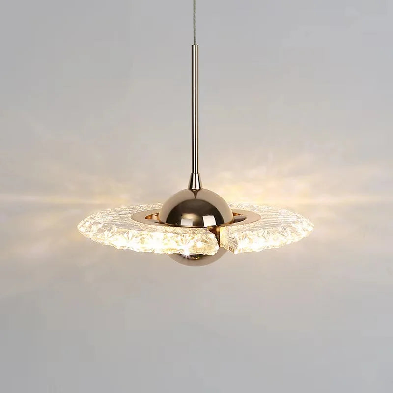 Modern pendant light with crystal shade on a neutral background