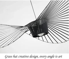 Black decorative item with fan-like design on a white background